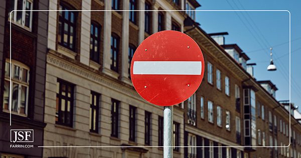 A red and white NO ENTRY sign post in a town in Denmark.