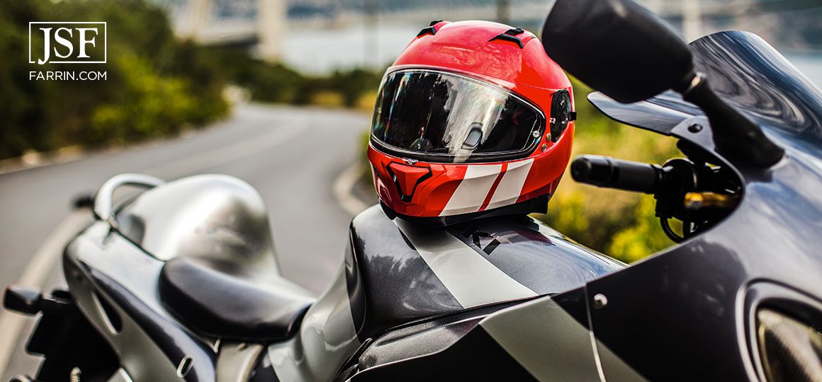 A grey black motorcycle and a red helmet