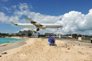 a plane just over a beach about to land
