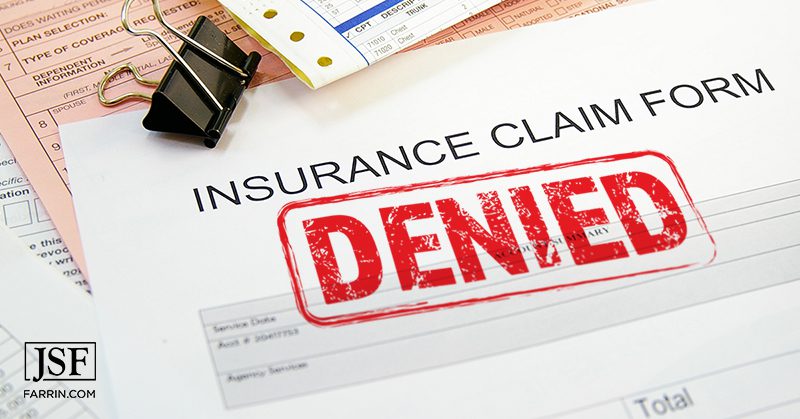 A bright red "denied" stamp an insurance claim paperwork.