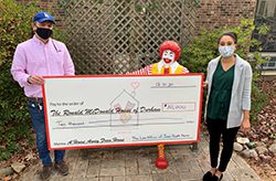 Chelsea Ragan from James Scott Farrin presenting a donation check to Ronald McDonald House in Durham