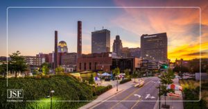 RJR tobacco smokestacks against the Winston-Salem, NC skyline at sunset.