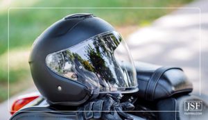A black motorcycle helmet and leather gloves.