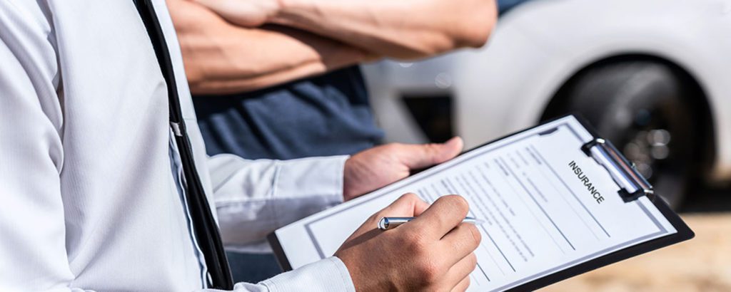 Insurance agent working during on site car accident claim process