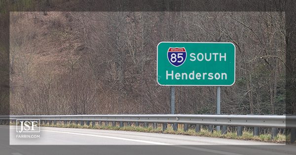 A green highway sign for interstate 85 (I-85) South and Henderson in North Carolina.