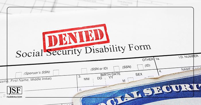 Bright red DENIED stamp on a social security disability application form.