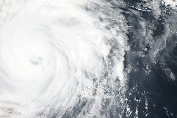 Satellite view of a hurricane off of the coast in the ocean.
