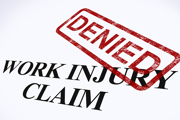 DENIED stamp across a work injury claim form.