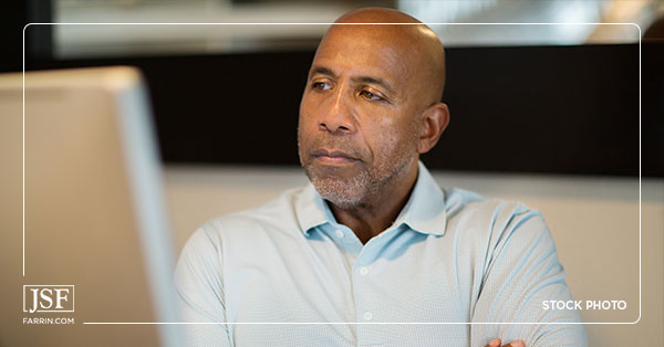 Upset man sits arms crossed in front of computer because his Social Security Disability was denied