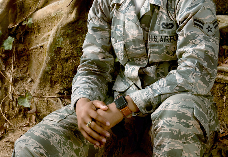 US Air Force soldier in fatigues, seated.