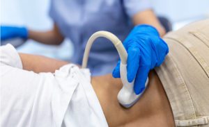 Imaging specialist performing a liver scan on a patient.