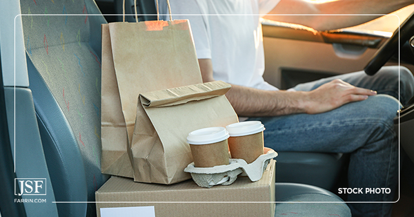 A DoorDash driver drives food and beverages to their destination