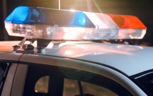 Bright red and blue lights on top of a police car.