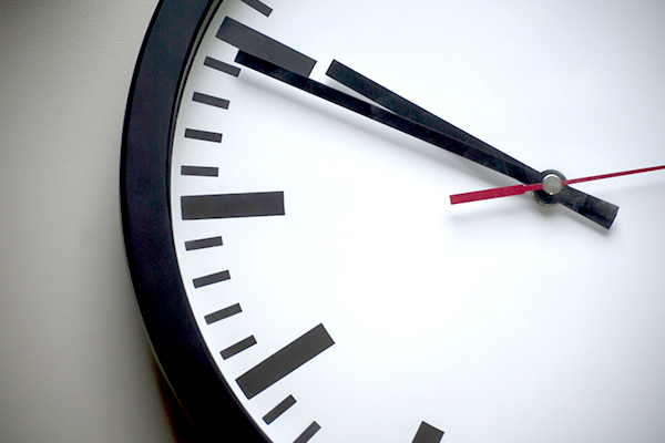 Close up of an analog clock on a wall.