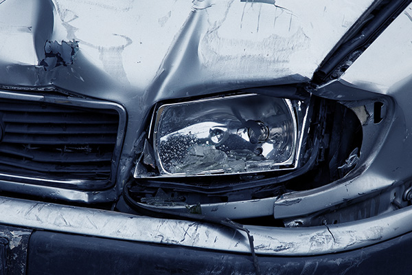 Close up of the broken headlight of a car after a crash.
