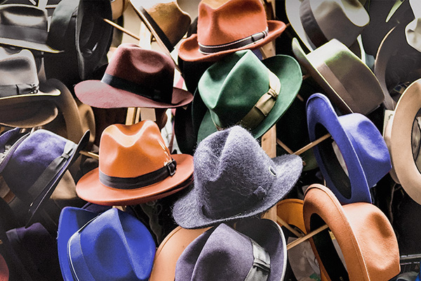 Racks and hangers of dozens of colorful felt men's hats.