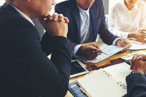 A meeting in a conference room with several attorneys looking over documents.