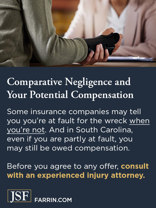 A person holding their injured wrist while talking to a personal injury lawyer.