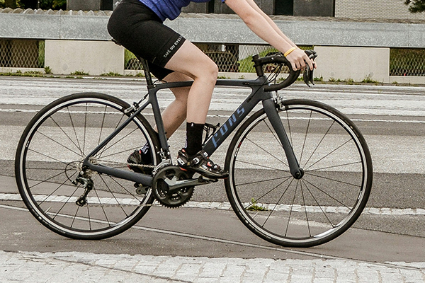 A person on a bicycle on an urban road.